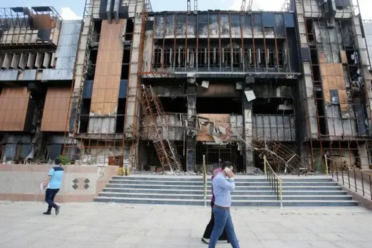 Iraqi students walk near a building of the central Library of the University of Mosul, May 14, 2018. Image by Khalid Al-Mousily for Reuters. Iraq, 2018. </p> <p>