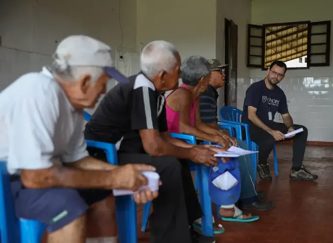 Several residents of Prata, a former leprosy colony in northern Pará, discuss issues with Dr. Josafá Barreto, a physical therapist, during one of the village’s public town hall meetings. Image by Anton L. Delgado. Brazil, 2020.