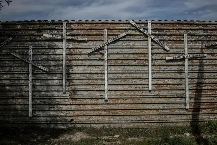 Families are known to put crosses on the wall bearing the names of loved ones who died attempting to cross the border. Image by James Whitlow Delano. Mexico, 2017.