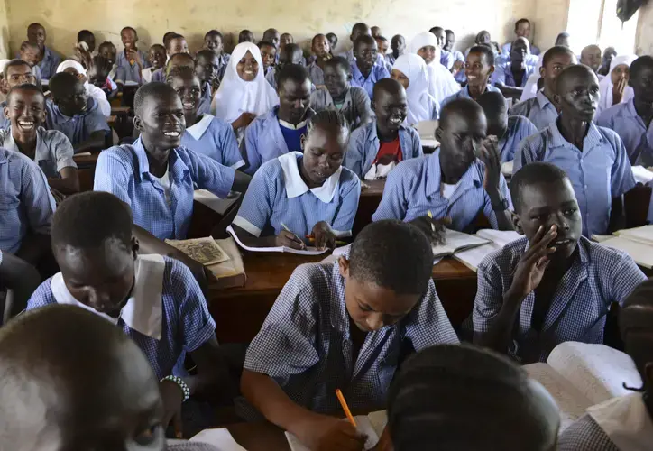 In Kakuma, it is common for students of many ages to learn together in a single classroom. Image by Rodger Bosch for UNICEF USA. Kenya, 2018.