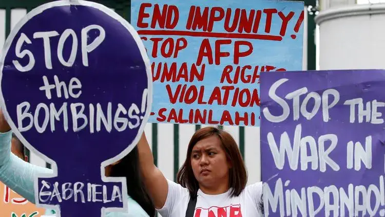Demonstrators in Manila on July 7 protest Philippine President Rodrigo Duterte's declaration of martial law for the southern region of Mindanao. Image by Bullit Marquez. Philippines, 2017. 