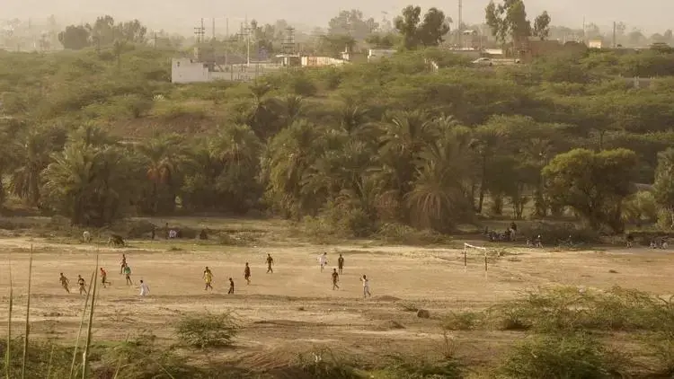 Children play a game of soccer in a field near Mir Ali. Image by Umar Farooq. Pakistan, 2017.