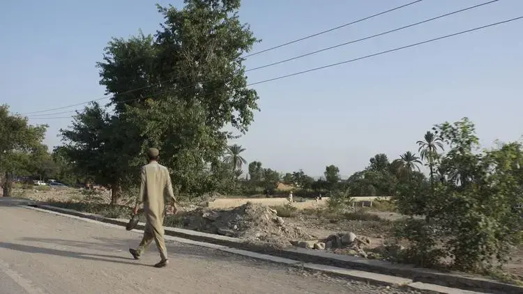 A man walks past destroyed homes near Mir Ali. Image by Umar Farooq. Pakistan, 2017.