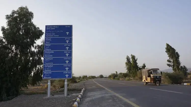 A signpost on the newly constructed road from Miramshah to the Afghanistan border, at the entrance to the military headquarters. Image by Umar Farooq. Pakistan, 2017.
