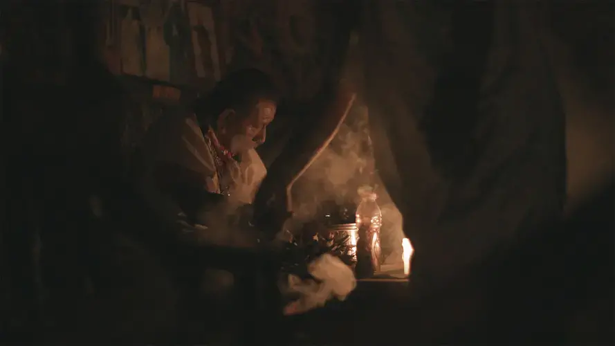 Elder shaman Humberto Piaguaje prepares yagé for the night’s ceremony, ancestral Siona territory, Putumayo, Colombia. A still from the New Yorker film “SIONA: Amazon’s Defender’s Under Threat.” Image by Tom Laffay. Colombia, undated.