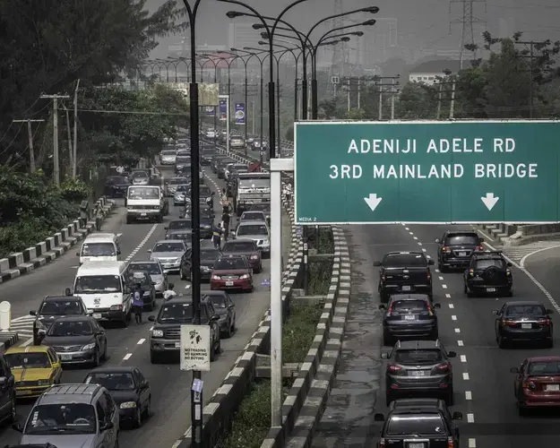 The roads are jammed daily with decrepit vehicles filling the air with auto exhaust fumes. Diesel-guzzling generators power everything from shop freezers to internet transmitter substations. Image by Larry C. Price. Nigeria, 2018.