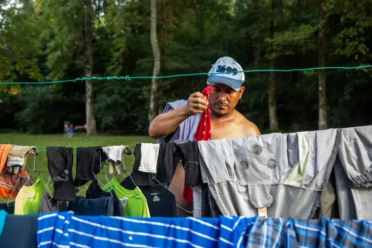 A farmworker named Fransisco dries his clothes on a clothesline at a Johnston County farmworker camp on Thursday, August 27, 2020. Image by Travis Long. United States, 2020.
