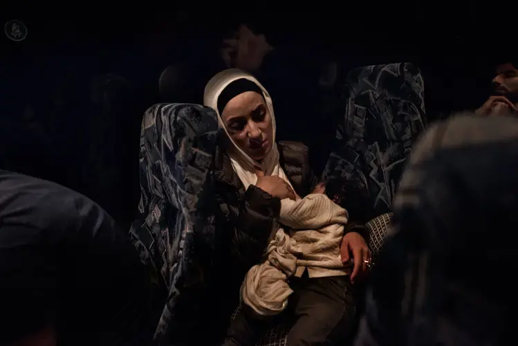 Syrian refugee Taimaa Abzali sleeps, exhausted, as she and her family make their way though the lonely and desolate highway through the forest toward their new home in Polva, Estonia. Image by Lynsey Addario. Estonia, 2017. 