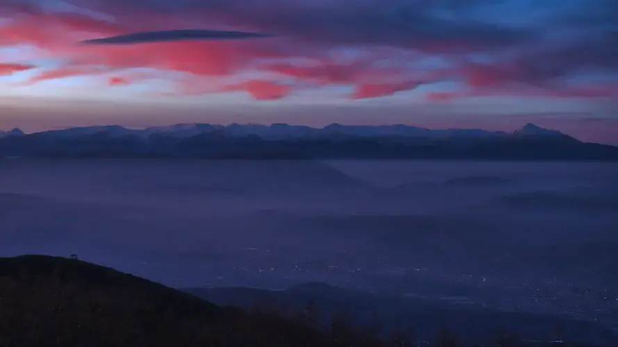 When the winds slow and warm air high in the atmosphere presses colder, heavier air down into the Skopje valley, the haze settles over the city like a quilt. Image by Larry C. Price. Macedonia, 2018.