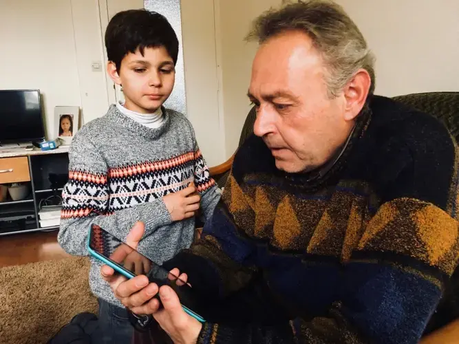 Mahmoud al-Hayek and his son Assad in their apartment in Saint-Nazaire, where they were placed by the EU’s relocation program for refugees. The family is originally from Aleppo, Syria. Image by Jeanne Carstensen. France.