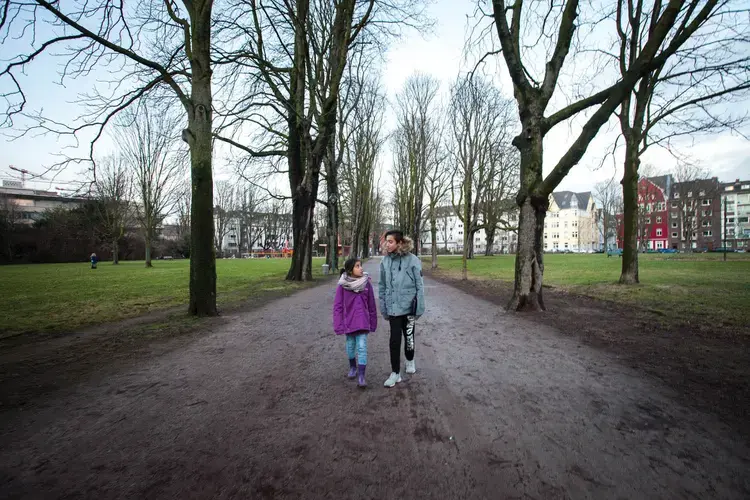 Milad (right) with his sister Mahya at the Frankenplatz park near their shelter in Düsseldorf. Image by Diana Markosian. Germany, 2017.