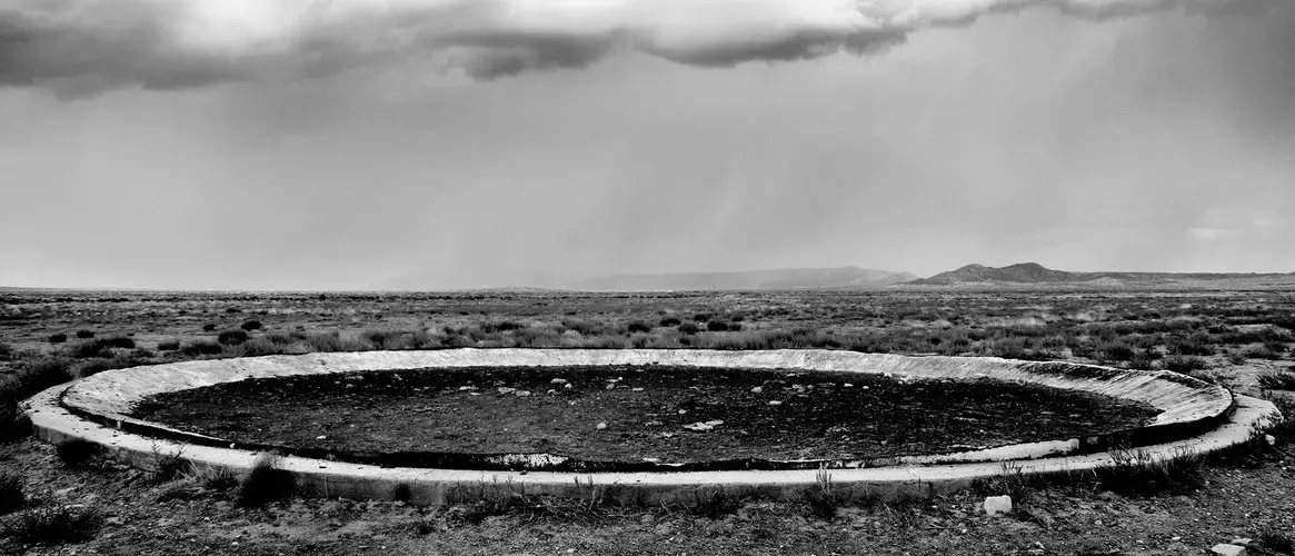 Red Mesa, Ariz. | The remains of a water­storage tank razed because of uranium contamination; for decades during the Cold War, mines in the Navajo Nation produced the uranium used for nuclear weapons. Image by Matt Black—Magnum Photos for TIME. United States, 2019.