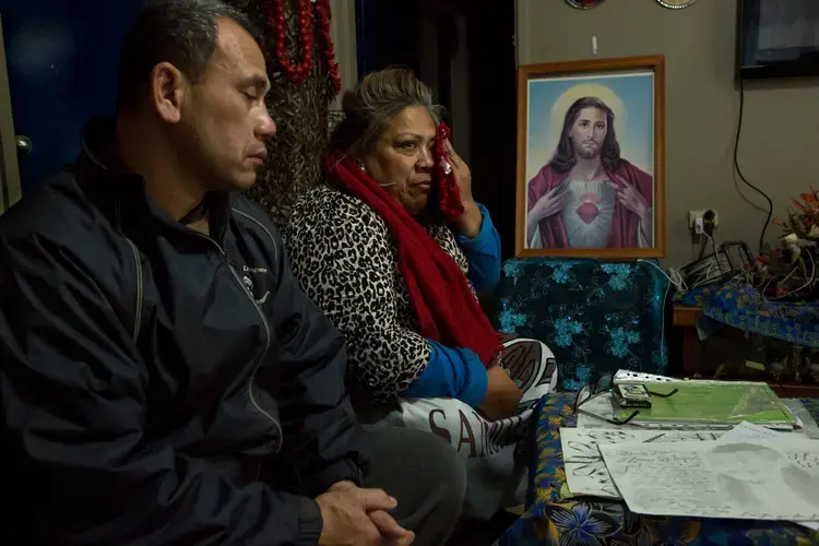 Mr. Togatuki and his wife, Atagai, with some of the items returned to them from their son’s prison cell after his suicide. Image by David Maurice Smith for The New York Times. Australia, 2018.