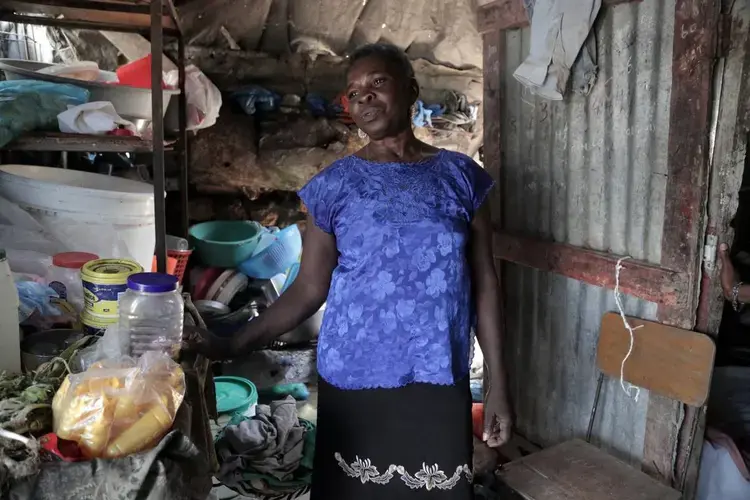 Manette Francois, 58, says that before the Jan. 12, 2010, earthquake she had an easier life than today. She lives in a tent city, Teren Toto, in Delmas, in a tin shack that doubles as living quarters and neighborhood grocery store. Image by Jose A. Iglesias. Haiti, 2019.