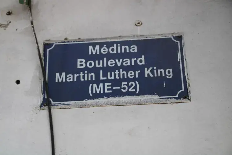 In Dakar, a street sign with King's name is placed high on a building for people walking down the street to see. Image by Michelle Tyrene Johnson. Senegal, 2019.