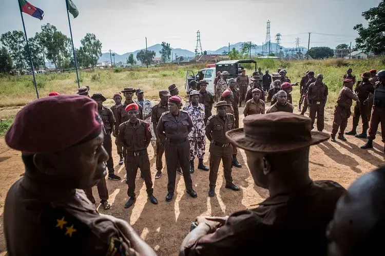 Members of the Vigilante Group of Nigeria, Barkin Ladi Division, stand at attention before leaving their base for patrols and checkpoint duties in Barkin Ladi on Oct. 22. Image by Jane Hahn. Nigeria, 2018.