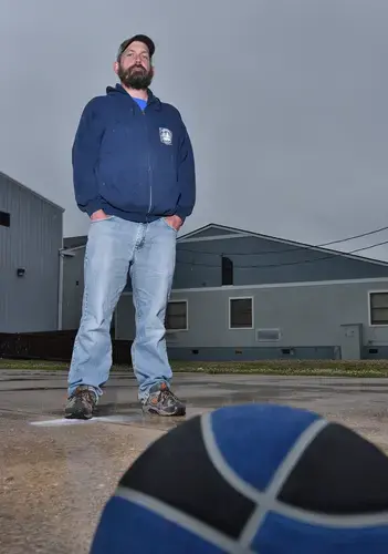 English teacher Charles Temple stands outside of the vacant Ocracoke School on Tuesday May 19, 2020, as the tail end of Tropical Storm Arthur heads east into the Atlantic Ocean. Image by Dylan Ray. United States, 2020.