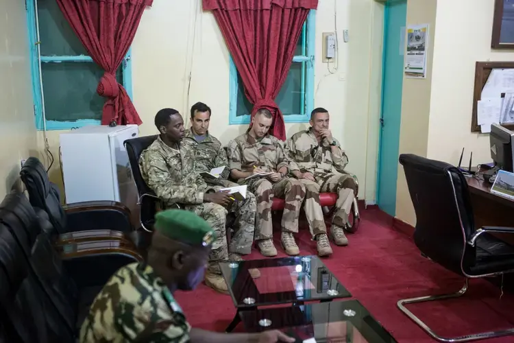 American and French soldiers attend a daily briefing with the Nigerien military commander in charge <br />
of the fight against Boko Haram at a Nigerien military base in Diffa, Niger. Image by Joe Penney. Niger, 2018.