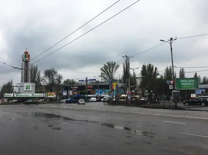 Traffic circle in the Quarter 95 neighborhood in Kryvyi Rih, eastern Ukraine, Volodymyr Zelenskiy's hometown. The green billboard features a campaign ad with the message: 'End of the era of greed.' Image by Nina Jankowicz/The World. Ukraine, 2019.