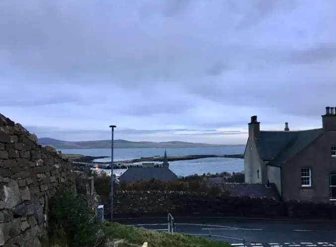 A view of the water and the other end of the Orkney mainland from the top of a hill in Stromness. Image by Maggie More. United Kingdom, 2020.<br />
