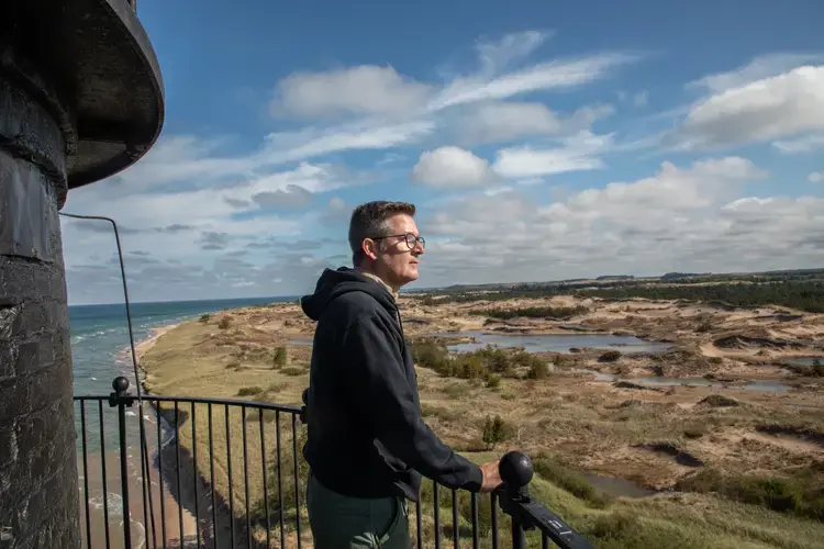 Jim Gallie, park manager at Ludington State Park, looks down from the Big Sable Point Lighthouse in Ludington, Michigan. It was built in 1867. Image by Zbigniew Bzdak/Chicago Tribune. United States, 2020.