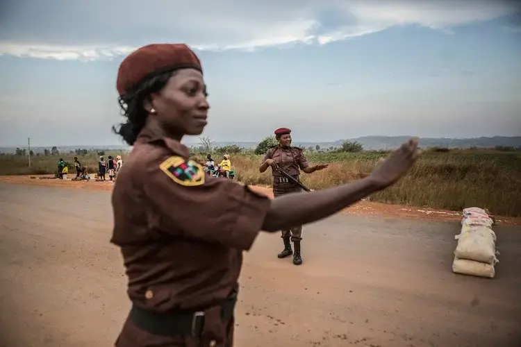 Esther Choji, 38, and Sarah Dung, 39, members of the Vigilante Group of Nigeria direct traffic at a checkpoint in Barkin Ladi on Oct. 24. Image by Jane Hahn. Nigeria, 2018.