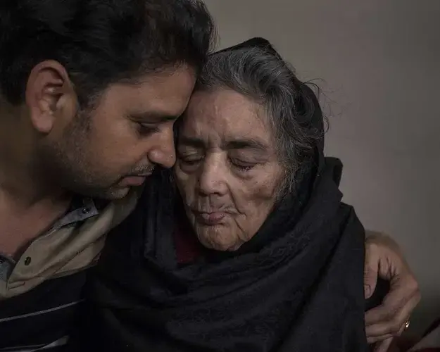 Rohit Pandey, a banker who lives in Los Angeles, is back home in Patna visiting his mother, Shanti Pandey, in their middle-class home. Pandey is suffering from both Parkinson’s disease and a chronic lung condition. Image by Larry C. Price. India, 2018.