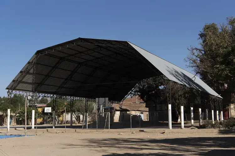 One of the soccer fields in Tarata. This is called the Jarkapampa, and the roof is new. Tarata residents that have not been to Tarata in years have not yet seen it. Image by Carey Averbook. Bolivia, 2016.