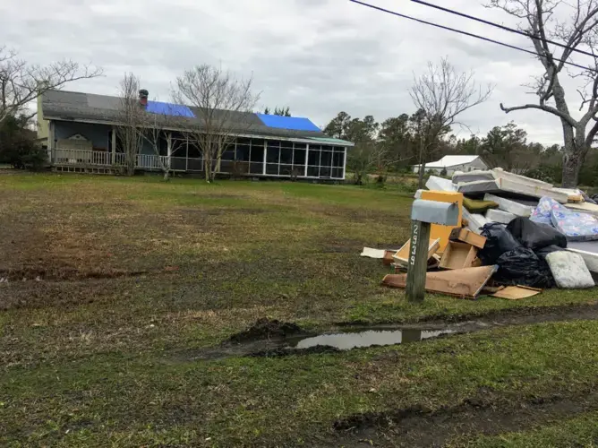 Following Hurricane Florence, ruined belongings were piled outside of homes, like this one in Carteret County, North Carolina. Floodwaters ravaged the interior of homes and survivors had to replace furniture and other possessions, as well as repair their homes. Image by Erika Layko. United States, 2018.