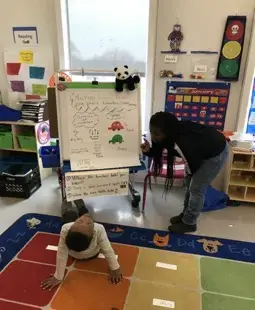 In the kindergarten class. Kelly was teaching a boy different patterns of movement. Image by Thea Gu. United States, 2017.