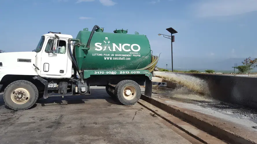 Companies and NGOs with sewage pump trucks like this one pay per cubic meter to unload raw waste at the sewage treatment facility at Morne a Cabrit, about an hour's drive from downtown Port-au-Prince. Image by Rebecca Hersher. Haiti, 2017.