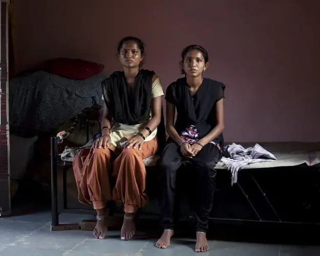 Sisters Puja Bharat Bhosale, left, and Aarati Bharat Bhosale lost their father, Bharat Shankar Bhosale, to the mob violence in Rainpada. Image by Prarthna Singh. India, 2018.
