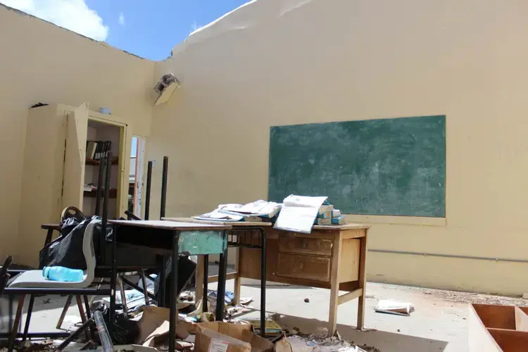 Three months after Hurricane Irma, Barbuda's lone primary school in the island capital Codrington remains roofless. An estimated 90 percent of properties were damaged in Barbuda when the Caribbean island was hit by Irma on Sept, 6, 2017. Image by Gregory Scruggs. Barbuda, 2017.