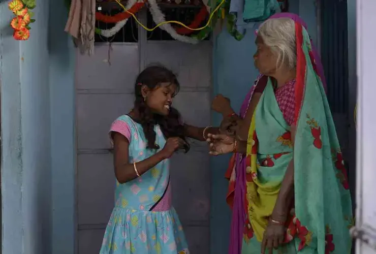 Rajni, 21, suffers with multiple disabilities causing her behavior to display shyness and anger. Her neighbours often scorn her because of her anger and sometimes they even hit back at her. Image by Rohit Jain. India, 2019.
