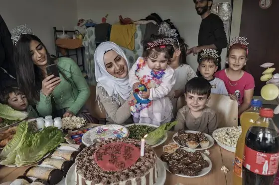 Taimaa Abazli celebrates the first birthday of her daughter Heln in a refugee camp in Kusel, Germany, on Sept. 13; she and her husband Mohannad were denied asylum in Germany but are appealing the ruling. Image by Lynsey Addario. Germany, 2017.