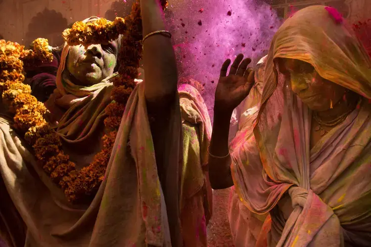 The exuberance of Holi, the holiday that includes flinging colored powders, was until recently thought inappropriate for widows. Aid groups, defying traditional prejudices against widows, now invite them to join celebrations like this Holi party in Vrindavan. Image by Amy Toensing. India, 2016.