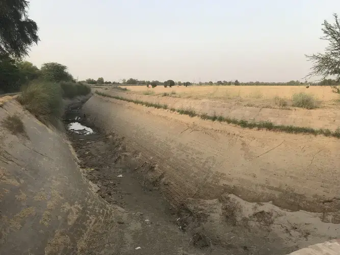 Precious resource: By mid-summer there won't be any puddles in this canal. Image by Miciah Thacker. India, 2018. 