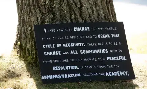 Former Oxford County Deputy Christina Sugars created this sign to call for police, including leaders of the Maine Criminal Justice Academy, to accept changes to their profession. Image by Linda Coan O’Kresik/BDN. United States.<br />
