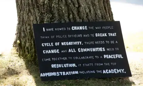 Former Oxford County Deputy Christina Sugars created this sign to call for police, including leaders of the Maine Criminal Justice Academy, to accept changes to their profession. Image by Linda Coan O’Kresik/BDN. United States.<br />