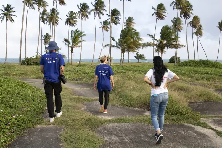 Beckles and members of her team walk around Playa Lucia, an abandoned beachfront property and popular spot to drop off dogs. Image by Jamie Holt. United States, 2019