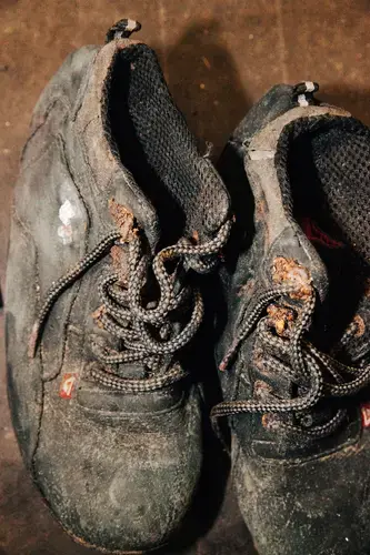 These shoes are among the personal items recovered with remains, which are stored at the Forensic Anthropology Center at Texas State University in San Marcos pending identification. The team goes through a rigorous documentation and organization process to catalog, clean and store the items by case numbers. Image by Julysa Sosa. United States, 2017.