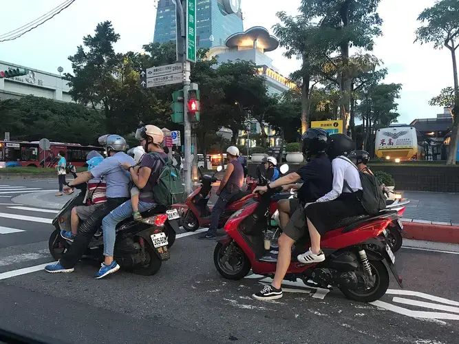 Taiwanese commuters often rely on scooters, sometimes crowding a whole family onto one of these vehicles. Image by Melissa McCart. Taiwan, 2018.