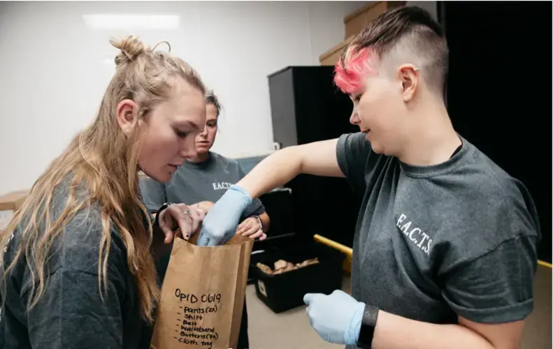 Anthropology seniors Cari Helgeson and Shelly White store migrant remains at the Forensic Anthropology Center at Texas State University in San Marcos. The team goes through a rigorous documentation and organization process to catalog, clean and store the items by case numbers. Image by Julysa Sosa. United States, 2017.