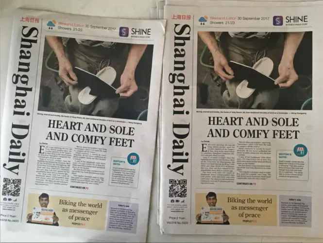 Copies of the Shanghai Daily set out on a table in the Daily's newsroom on Sunday, Sept. 30, 2017, in Shanghai, China. Image by Kelsey Kremer. China, 2017.