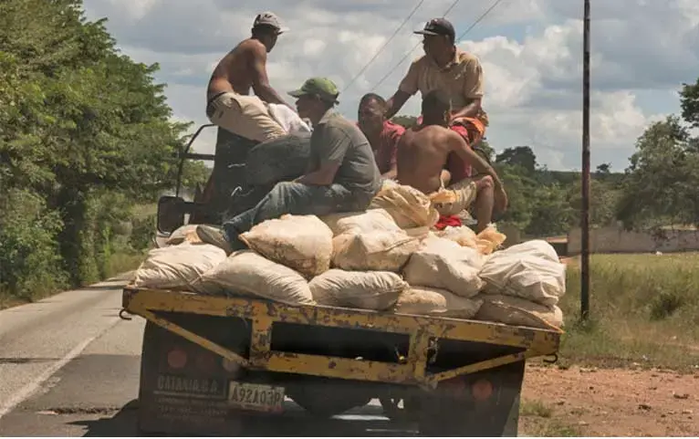 Small-scale miners in Bolívar state transport mineral ore to one of the nearby processing mills. They are rarely well rewarded for their grueling work yet suffer major risks to health and their lives. Image by Bram Ebus. Venezuela, 2017.