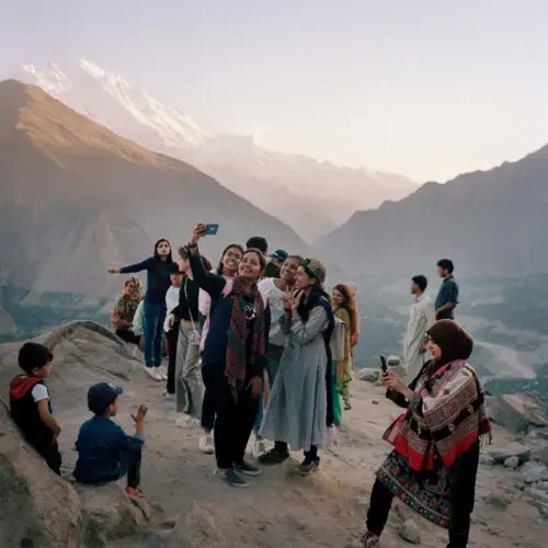 Tourists from Karachi pose for a selfie overlooking the Karakoram mountain range in the Hunza valley. The group of young women came to 'escape city life,' they said. Image by Sara Hylton/National Geographic. Pakistan, 2019.