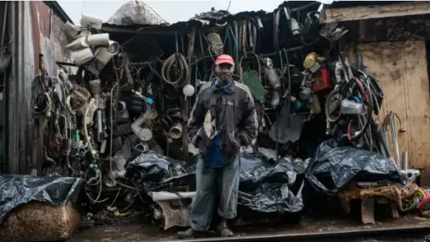 James Maina, a father of six, and a resident of Kibera, Nairobi, Kenya. He used to own a house next to the railway line in the Laini Saba neighborhood of Kibera. When the homes were demolished and new ones built by the Kenya Railways with funding from World Bank, he was lucky to get one room. Image by Peter DiCampo. 2018.