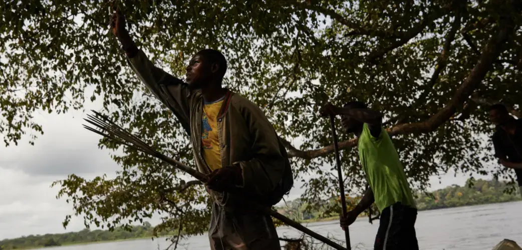 Area residents aboard a small boat in the Congo. Image by Hugh Kinsella Cunningham. Democratic Republic of the Congo, 2019.