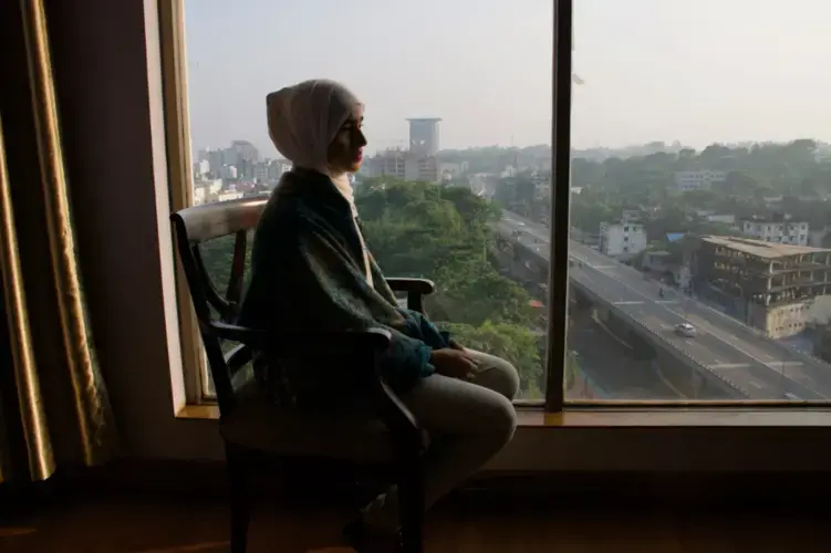 Formin looks out the window of her bedroom. Image by Sasha Ingber/ Music in Exile. Bangladesh, 2019.