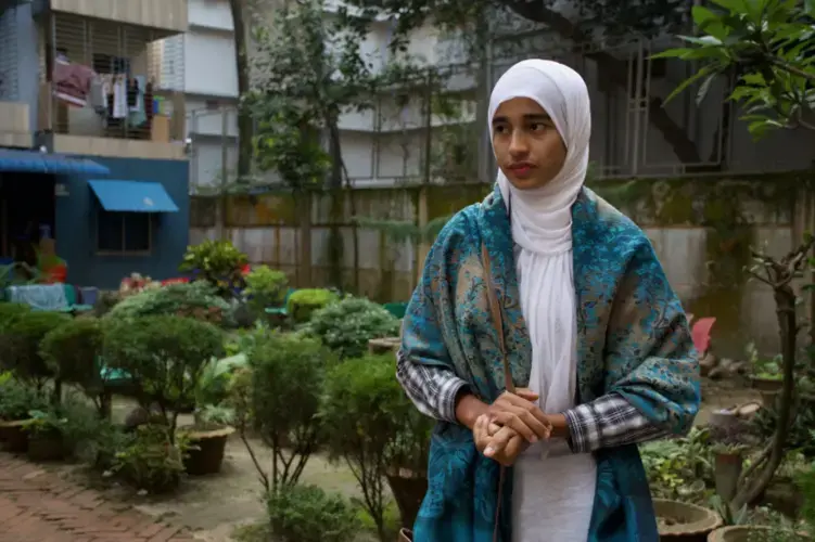 Formin in her backyard patio. Image by Sasha Ingber/ Music in Exile. Bangladesh, 2019.